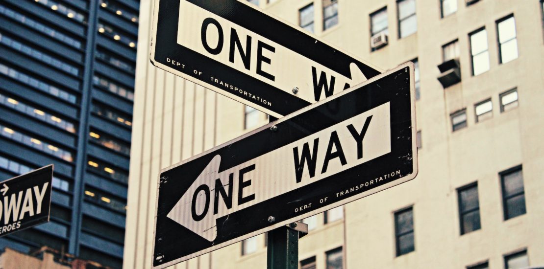 white and black One Way-printed road signages